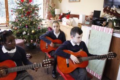 Guitarists and bell ringers perform for elderly